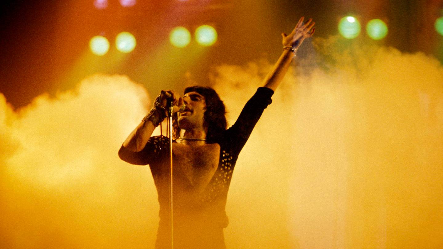 Freddie Mercury backstage at Live Aid followed by boyfriend Jim Hutton